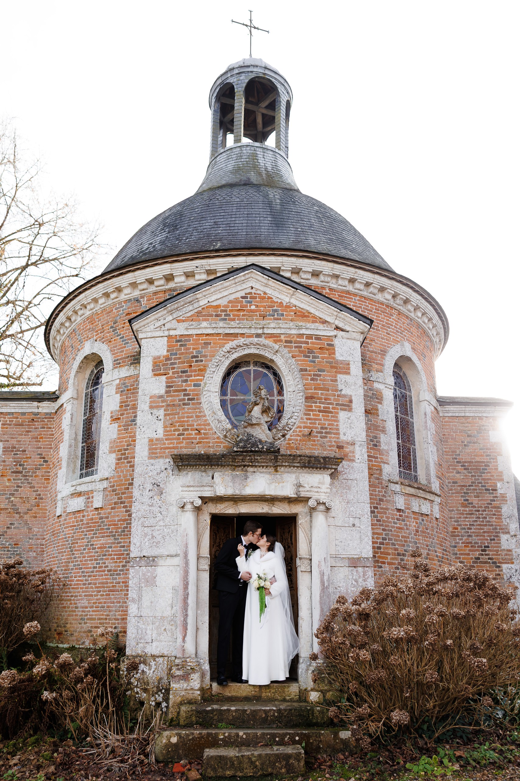 photo of the couple at the entrance to the church for the wedding